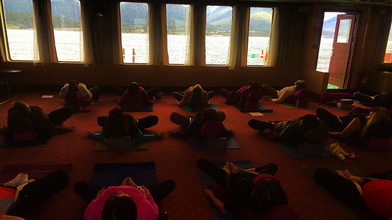 The passengers practice yoga ahead of a day's expedition. 
